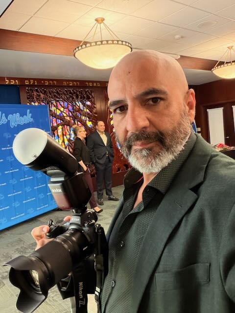 Angel R. Gutierrez holding his Nikon camera