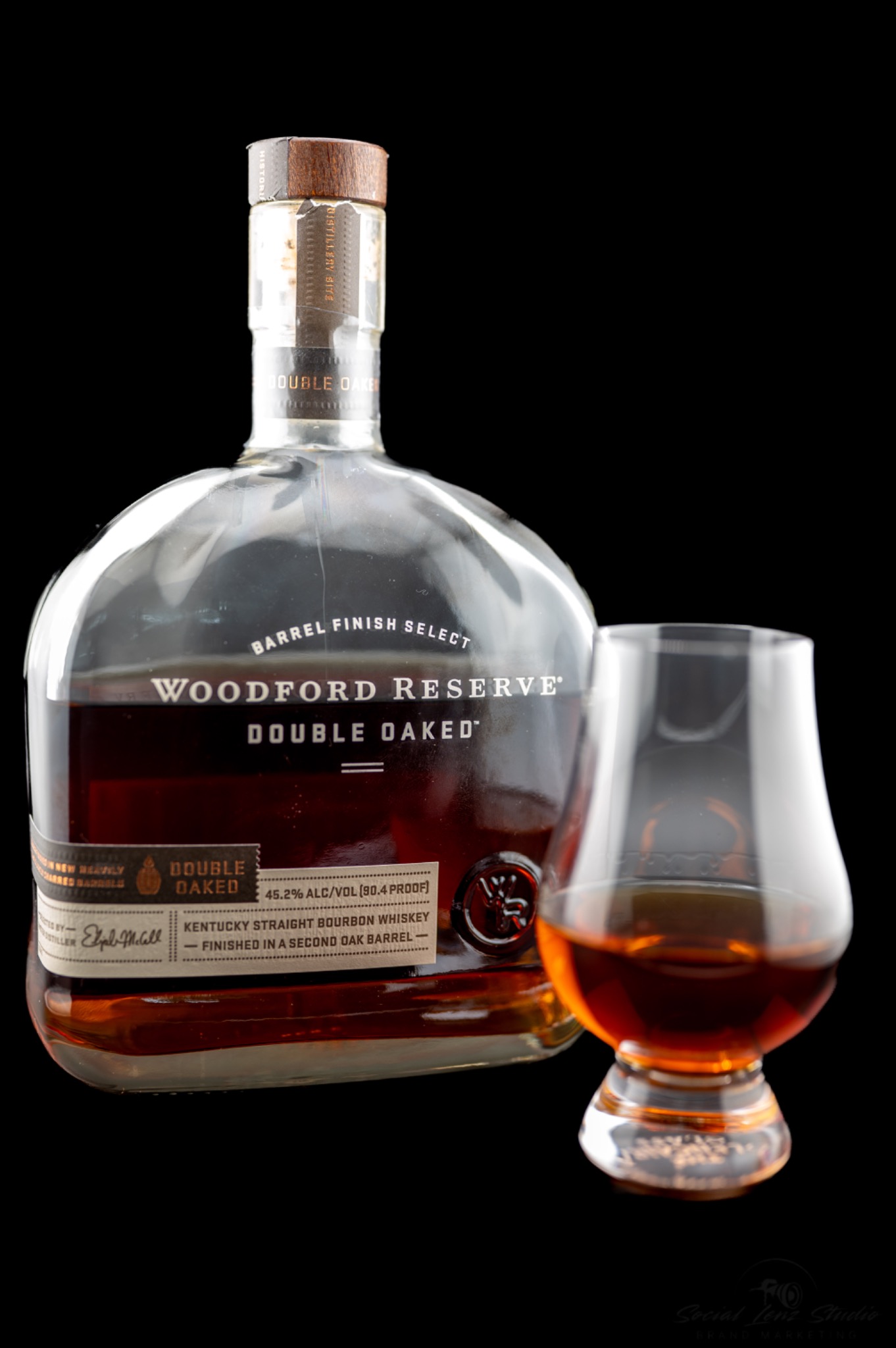 Studio product photograph of bourbon and glassware