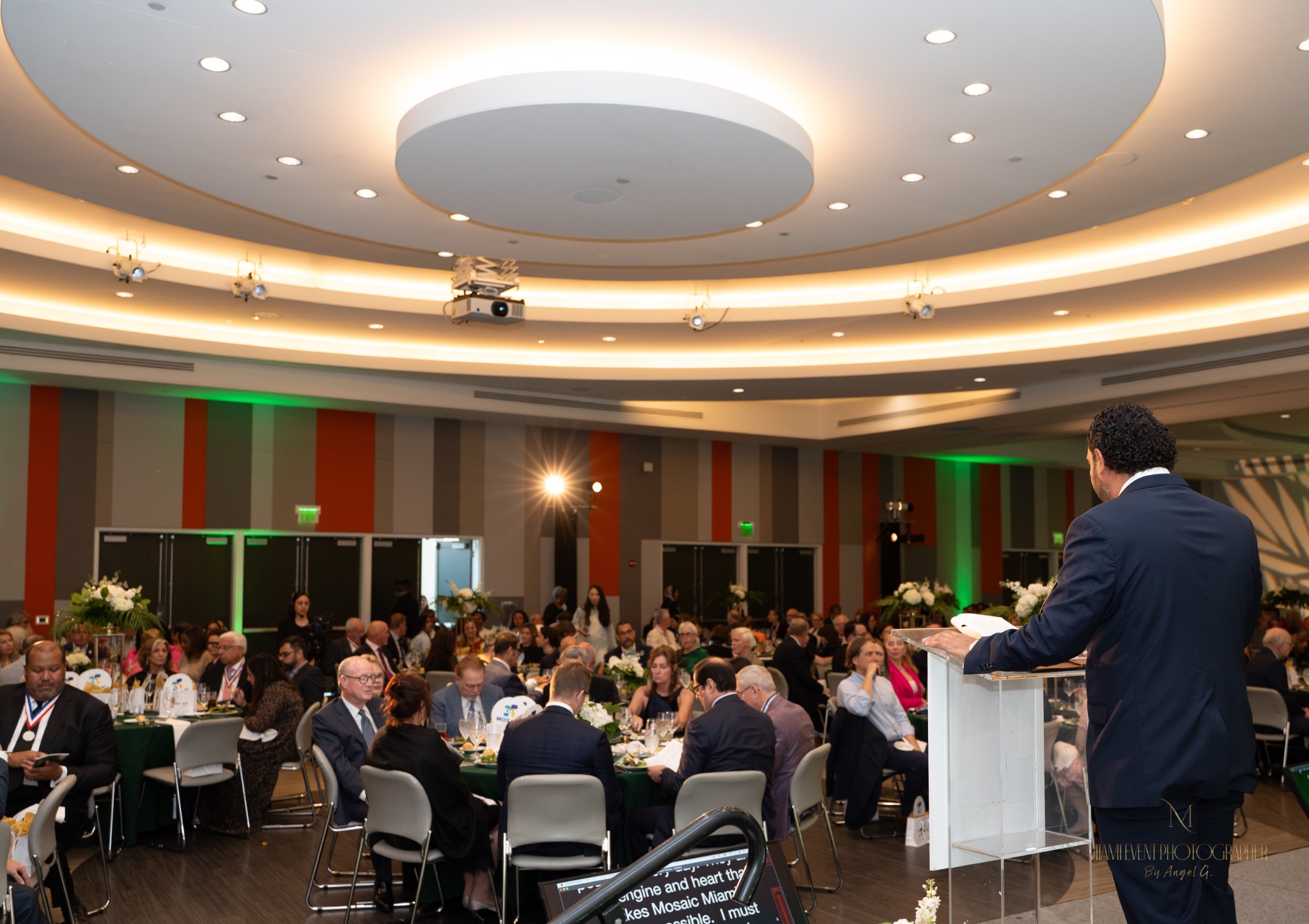 Speaker addressing guests at a formal Miami event