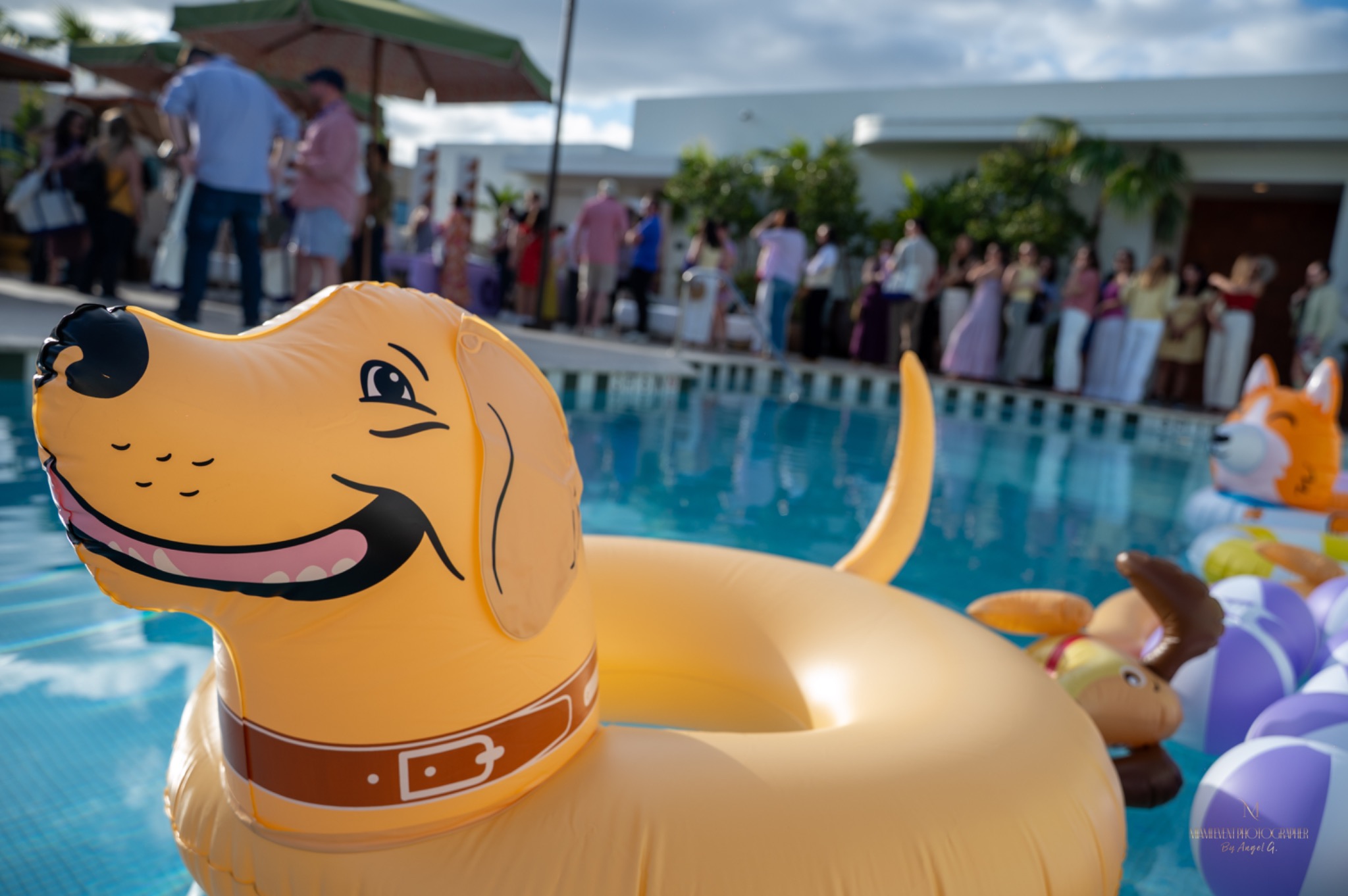 Colorful poolside celebration with guests in the background